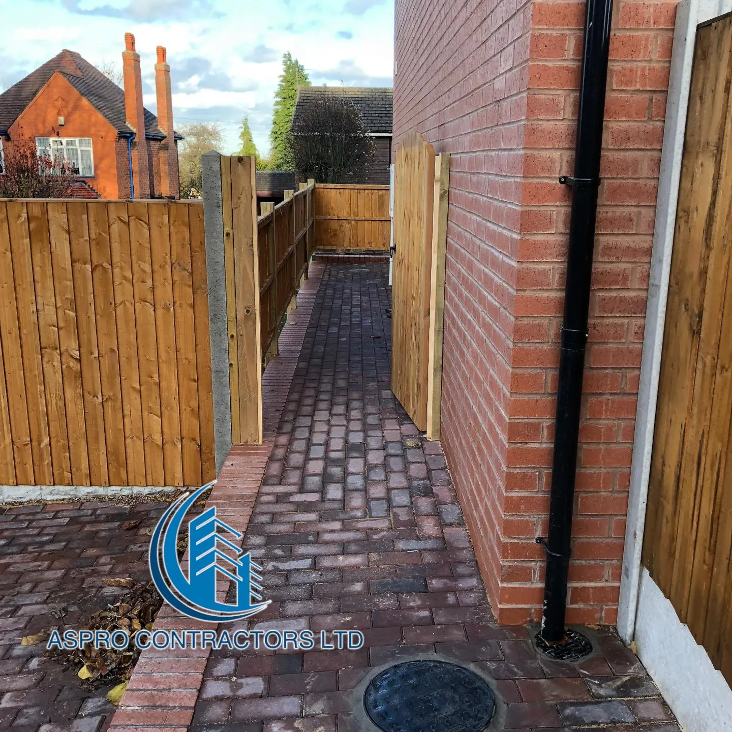 a brick sidewalk with a manhole in the middle of it